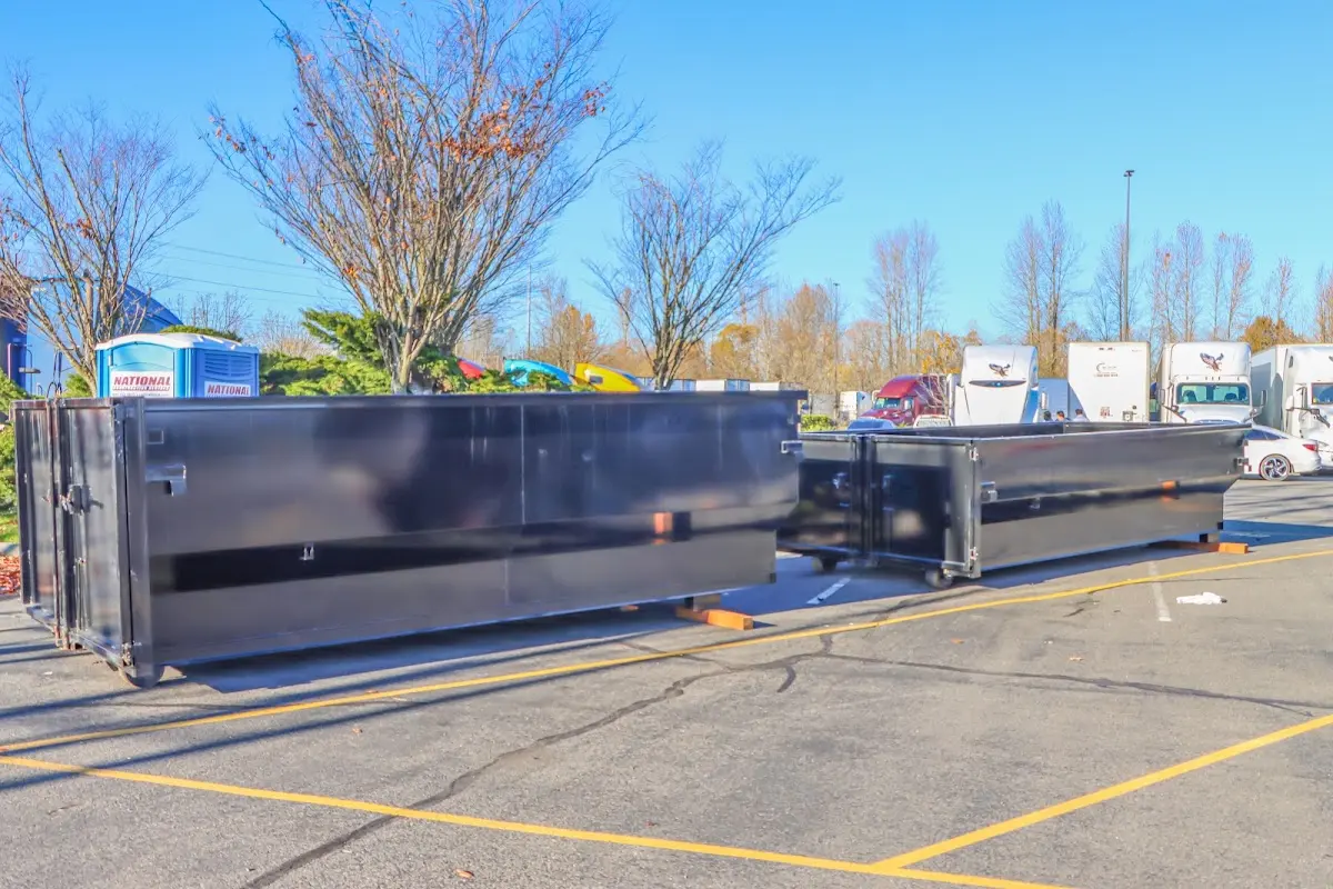 Professional dumpster rental service with roll-off container on residential driveway in McSwain